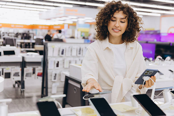 istock Woman comparing smartphones in electronics store 2231307212