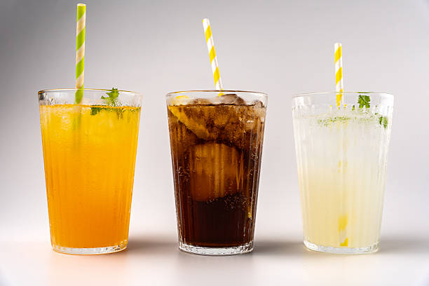 istock Three glasses with refreshing soft drinks, decorated with ice, lemon and mint leaves, ready to be enjoyed 2231308032