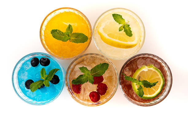 istock Summer cocktails with mint, raspberries, blueberries, lemon and lime, top view on white background 2231308148