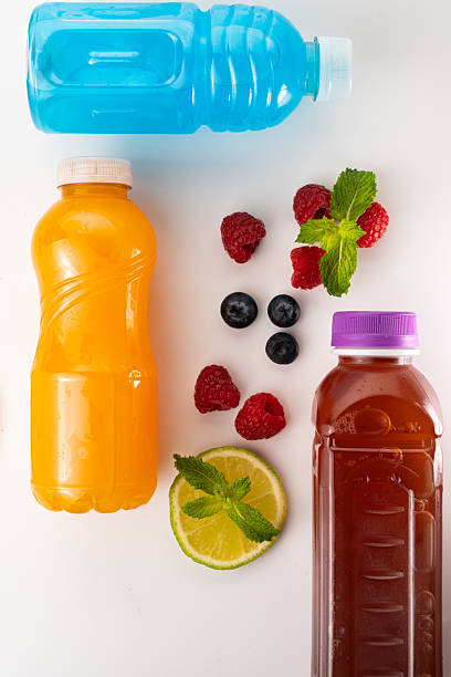 istock Isotonic drinks, vibrant fruit juices, and fresh berries arranged on a white background, celebrating a commitment to a healthy lifestyle 2231308335