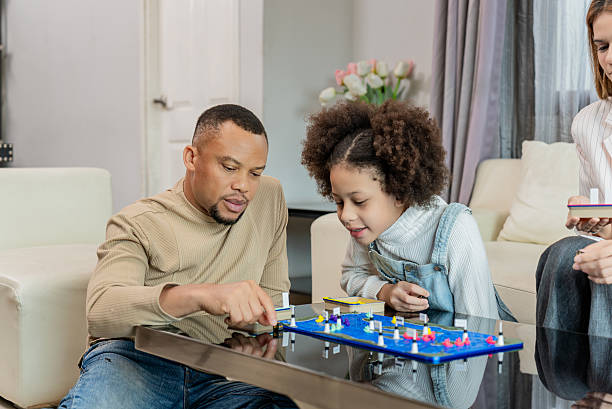 istock Upscale Family Bonding at Home – Father and Daughter Playing Board Game 2231309613