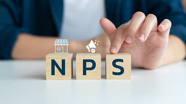 Net promoter score (NPS) concept for customer feedback and business analytics. Wooden blocks with NPS letters and icons representing customer experience and marketing.