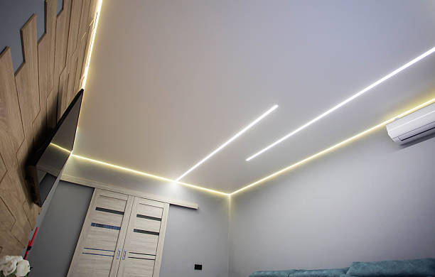 istock Beautiful modern stretch ceiling with yellow LED lines around the perimeter. Designer stylish ceiling in the hall. 2231313762