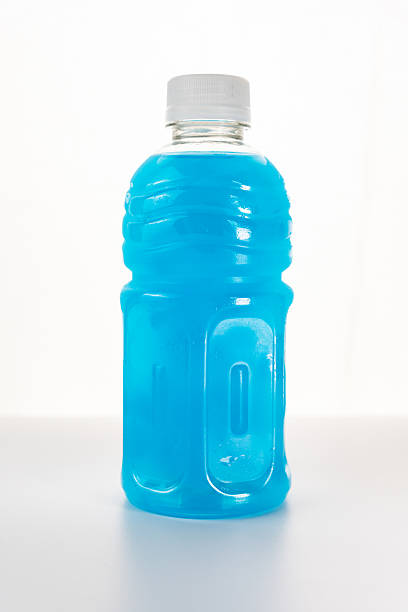 Energizing isotonic beverage replenishing electrolytes after workouts, featuring a vibrant blue liquid in a sleek plastic bottle