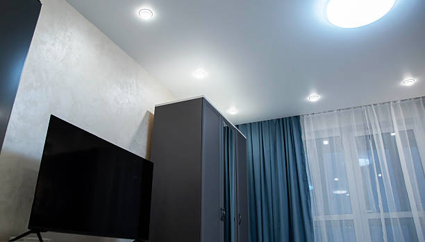 istock Sliding wardrobe, TV and suspended ceiling with lighting in a studio apartment against a background of turquoise curtains, beautiful interior 2231314752