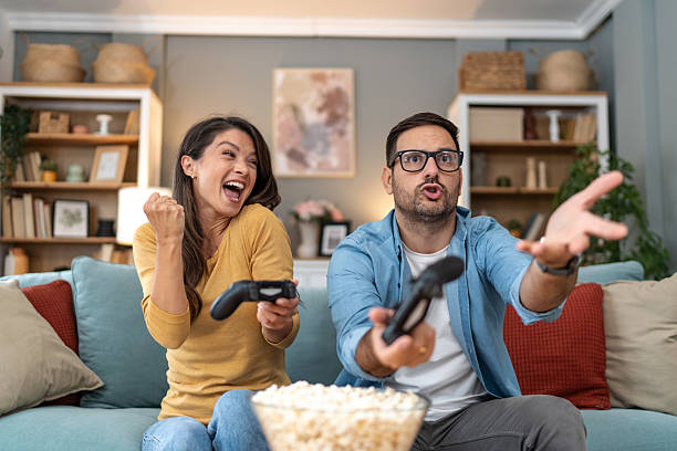 istock Excited couple playing video games at home 2231315075