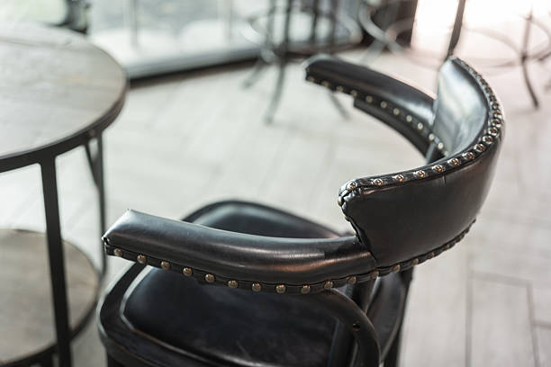A classic designed leather chair with backrest at the hotel lobby or living room. Interior furniture object, close-up with selective focus.