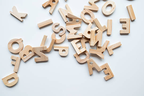 istock Wooden alphabet letters scattered randomly on white background 2231316591