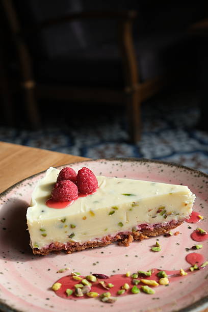 Slice of Pistachio Raspberry Cheesecake on Plate