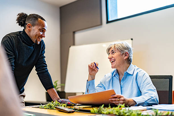 istock Coworkers talking at office 2231318104