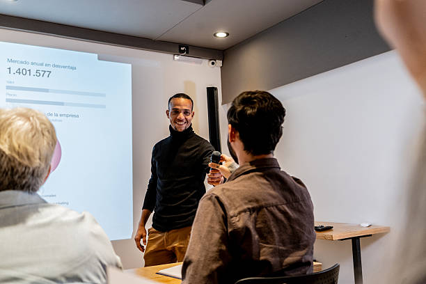 istock Mid adult man doing presentation during seminar at office 2231318208