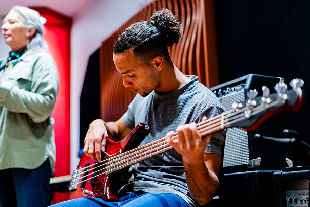 istock Young man playing bass at music studio 2231318905