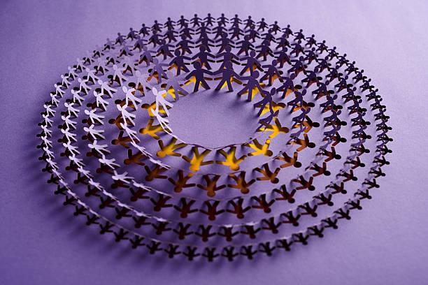 istock Spiral Paper Chain of Human Figures Symbolizing Unity and Connection 2231320440