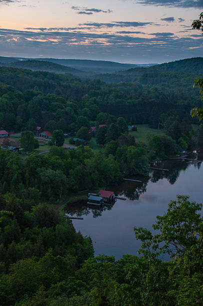 istock Twilight over a forest lake with cottages 2231321245