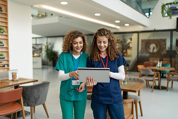 istock Two young nurses collaborating on a digital tablet in hospital cafeteria 2231322211