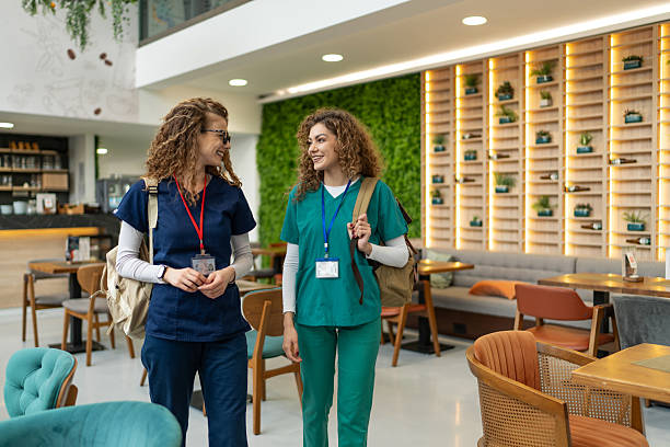 istock Two young nurses walking and talking in hospital cafeteria 2231322403