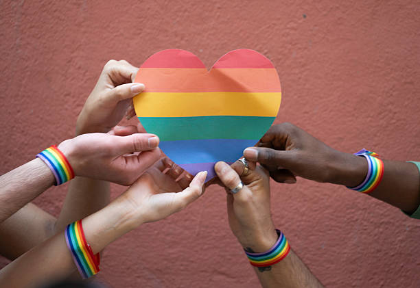 istock Hands holding rainbow heart supporting lgbtq+ community 2231323840