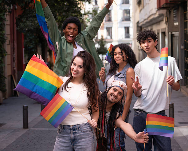 istock Young activists holding rainbow flags celebrating gay pride 2231323852