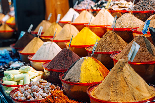Heaps of peppercorn and other spices at bazaar market stall