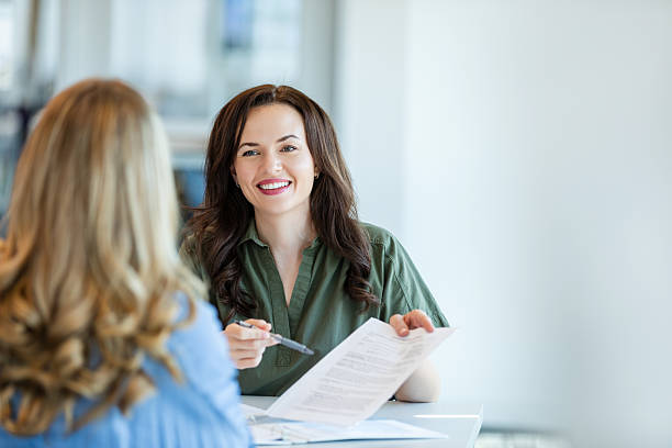 istock Two Women in Business Meeting, Discussing Documents 2231325712
