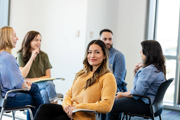 istock Confident Woman in Group Therapy Session, Smiling 2231325778