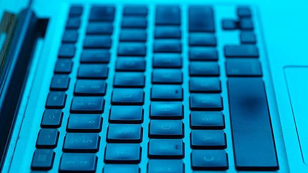istock Close up View of Blue Backlit Computer Keyboard Keys 2231336632