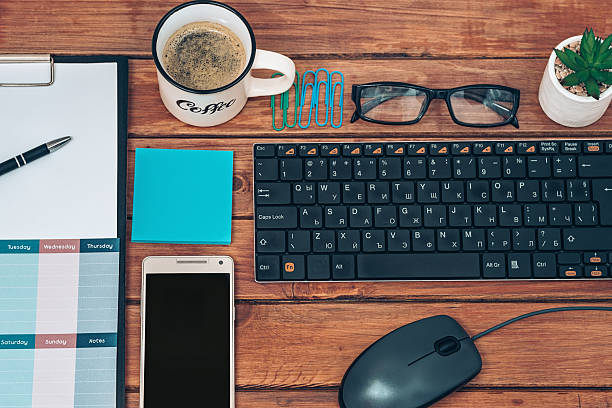 Making weekly agenda in the office with coffee cup horizontal shot