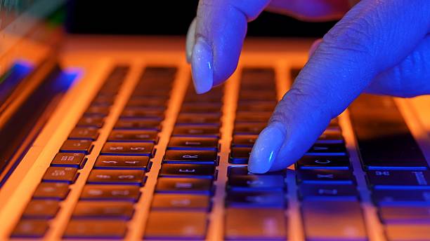 istock Close Up of Hands Typing on a Laptop Keyboard 2231337026