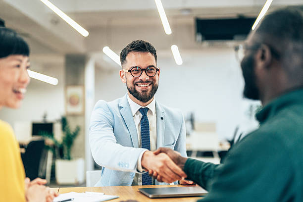 istock Meeting success. Business partners shaking hands 2231339305