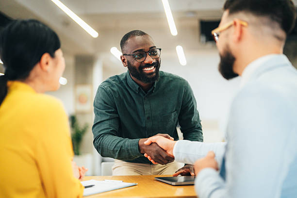 istock Meeting success. Business partners shaking hands 2231339347