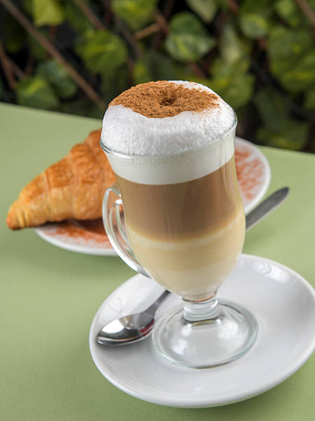 istock delicious hot chocolate, cappuccino with croissant 2231339487
