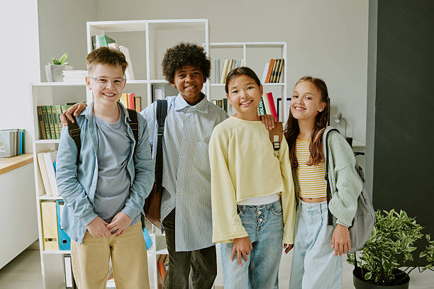 istock Group of Diverse Teenagers Smiling Together in Modern Classroom Setting 2231340419