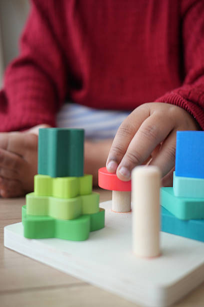 istock Child engages with colorful stacking blocks in a playful setting 2231342543