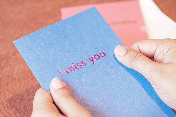 istock Person holding a card that expresses feelings of missing someone 2231343706