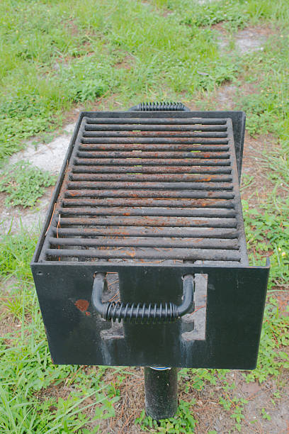 istock Rustic Grill in a Park Setting Ready for Cooking Outdoors in green grass. 2231345442