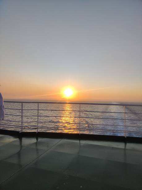 istock Ferry boat deck with sunset reflecting on calm sea 2231345675