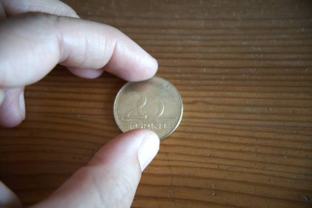istock One 20 Forint Coin in Hand on Table 2231353936