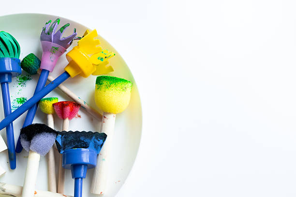 istock Colorful sponge paintbrushes on white background 2231355807