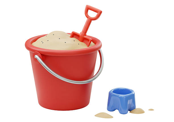 Colorful Toys Scattered Across Sunny Sandpit With Green Grass