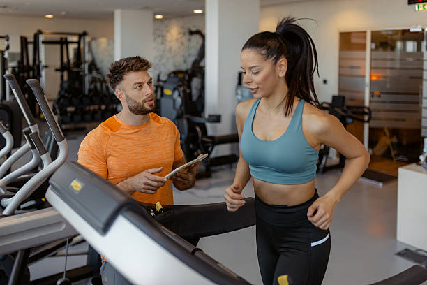 istock Athlete Training with Personal Trainer Using Digital Fitness App 2231360935