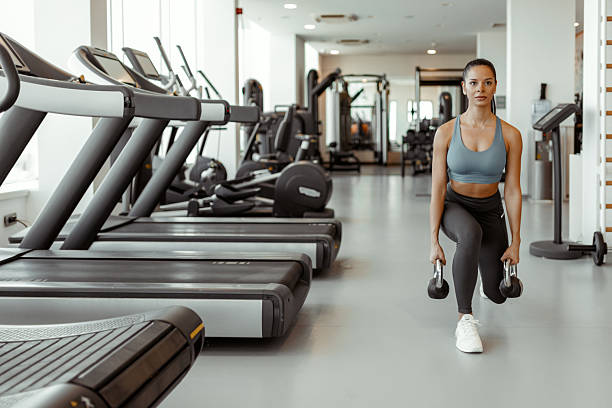 istock Female Fitness Enthusiast Practicing Lunges with Kettlebell 2231361026