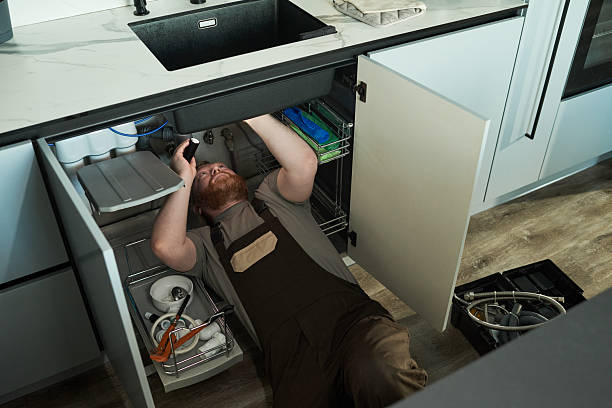 istock Caucasian Middle Aged Man Working under Kitchen Sink Installing Plumbing Pipes 2231361417