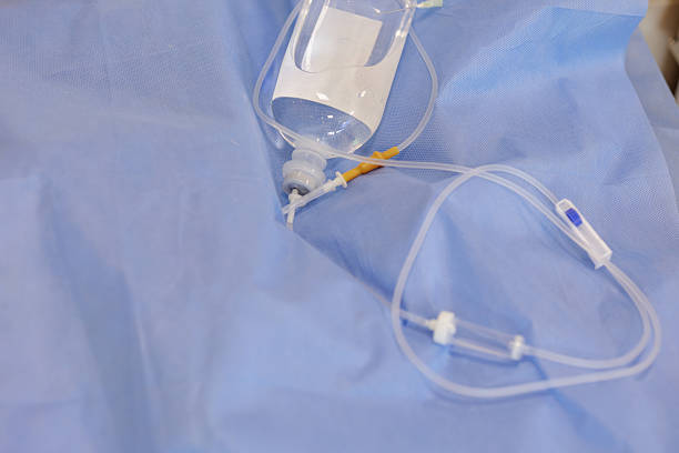 istock Infusion bottle with IV set on blue sterile drape in hospital 2231363410