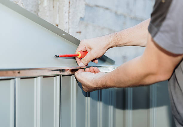 istock An unrecognizable man screwing screws with a screwdriver into a metal shed. 2231365176