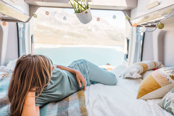 istock Woman Relaxing Inside Camper Van with Scenic View 2231368898