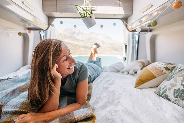 istock Woman Relaxing Inside Cozy Camper Van Bed 2231369138