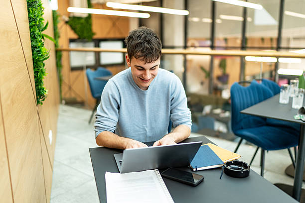 istock Young man working on laptop in modern office space 2231370412