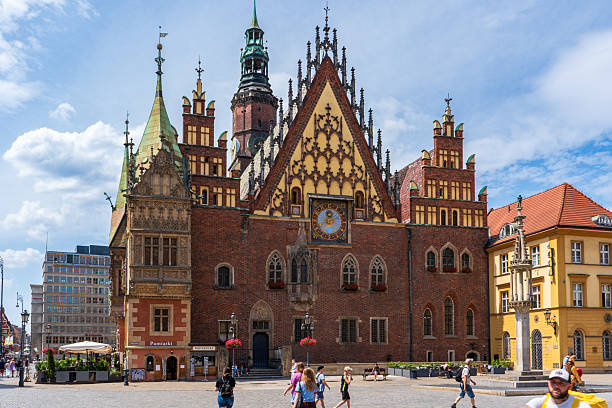 Wroclaw, Poland - 6th July 2025\nThe city hall in Wroclaw. People are walking around the city market square.