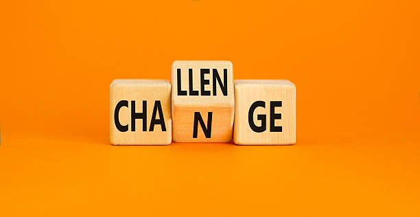 istock Challenge and change symbol. Concept word Challenge Change on wooden cubes. Beautiful orange table orange background. Business and challenge and change concept. Copy space. 2231374036
