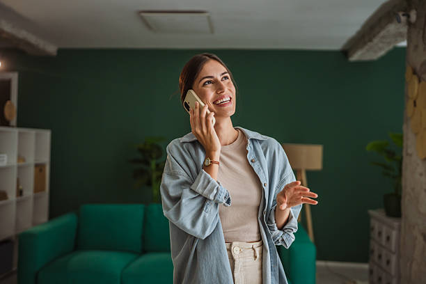 istock Smiling creative professional woman talking on mobile phone in modern office 2231374390